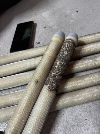 A close-up of charred and damaged multi-core composite ionization tubes from a Singapore installation.